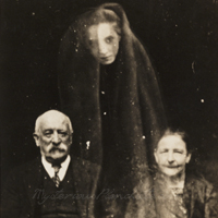 Example of an 1860s 'spirit photo' showing elderly couple and uninvited guest. 